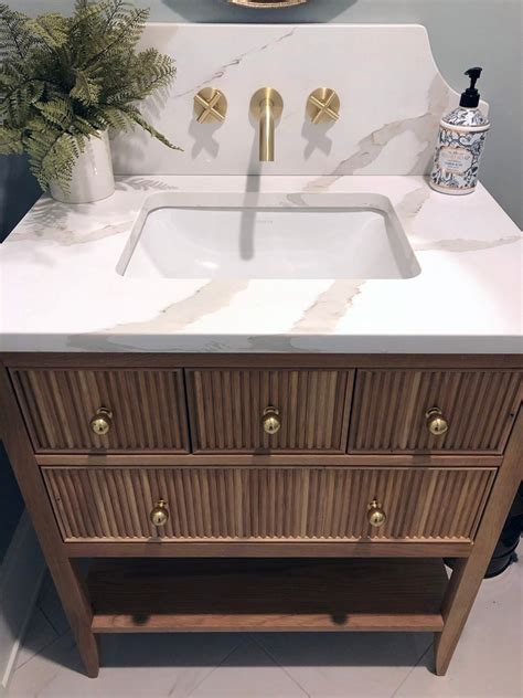 Sonoma white oak reeded vanity - Look no further than the Sonoma White Oak vanity. This elegant piece is constructed with solid oak and plywood, and features a beautiful reeded design. The white oak finish is perfect for creating a sophisticated look in your bathroom, and the vanity is also covered with a durable veneer to protect it from everyday wear and tear.